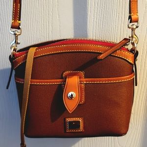 Brand new Dooney and Bourke Dome leather handbag with dust cover.